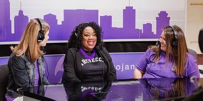 Photo from the set of the Trevecca news team with the news anchors.