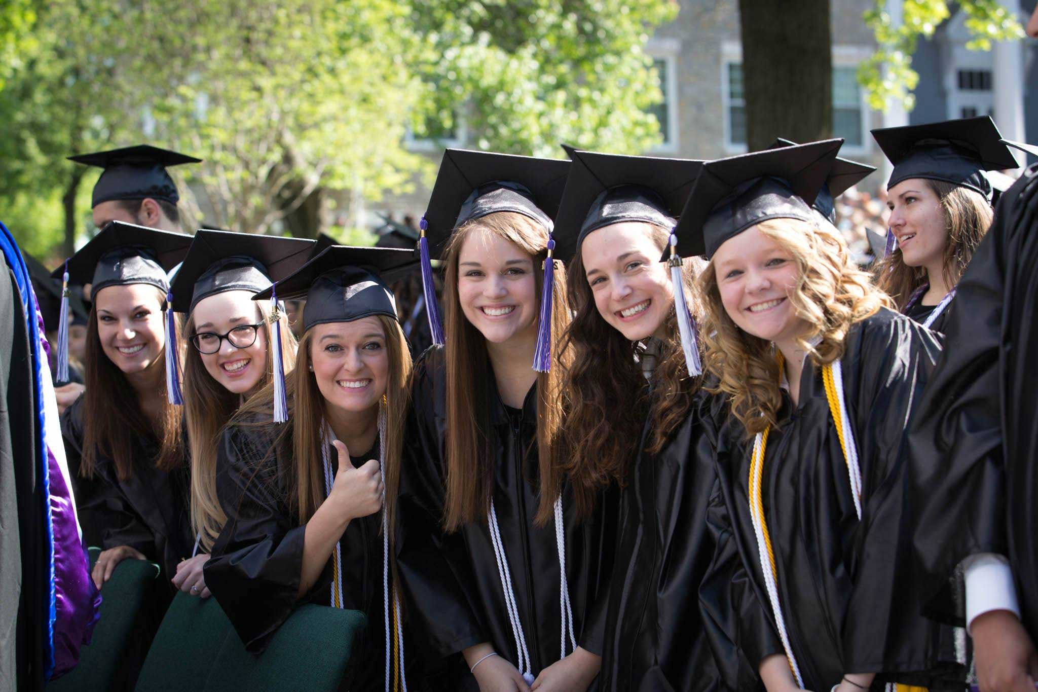 Trevecca students smile and wave at graduation.