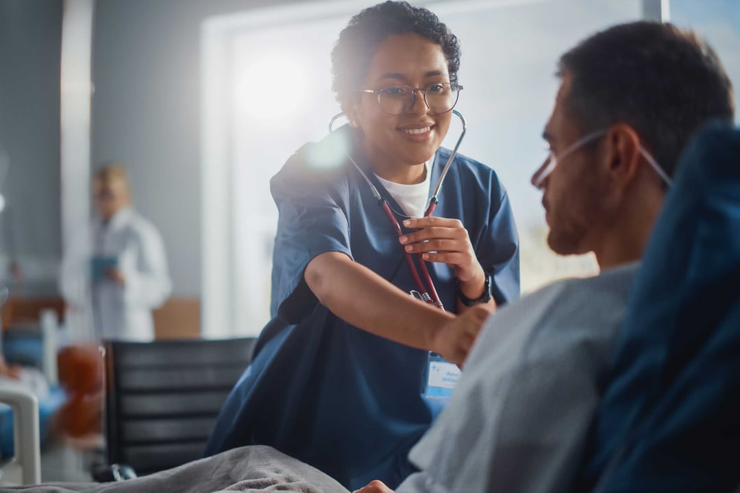 A nursing student takes the vitals of a patient.