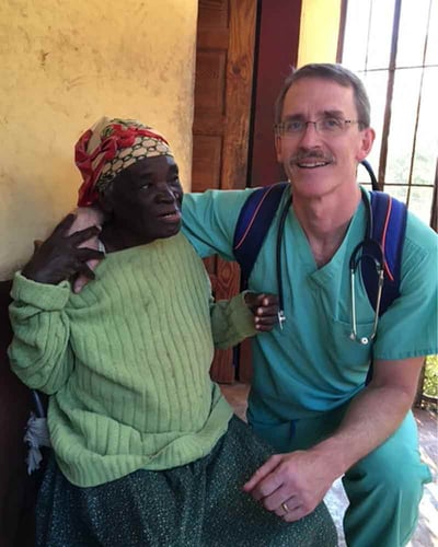 Dickenson poses for a photo with a patient.